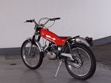 a red motorcycle that is parked in a garage