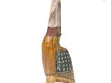 a close up of a wooden sculpture of a bird on a stand