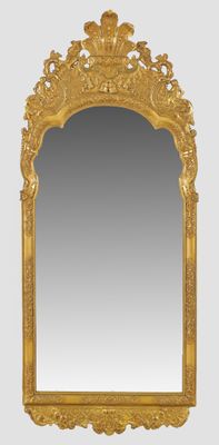 a gold framed mirror with a decorative design on it