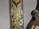 close up of a black and gold table with a floral design
