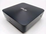 an asus laptop computer sitting on top of a white surface