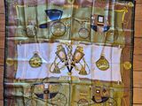 a scarf on the floor with a clock and other items
