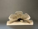 an image of a sculpture of a shell on a gray surface