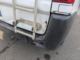 a white truck with a ladder attached to the back of it