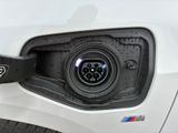 an electric car plugged in to a charging station with a bmw logo on it