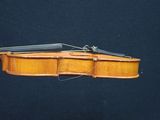 an old violin with a bow on a black background