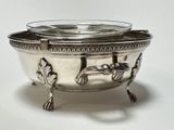 a silver bowl with a horse on it on a stand