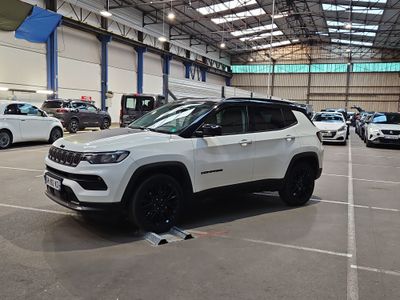 a white jeep parked inside of a building in a parking lot