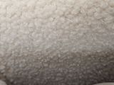 a close up of a sheep ' s head with white fur