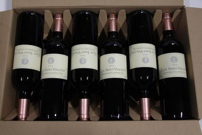 six bottles of wine in a box on a table