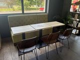 a table and four chairs in a room with a large window