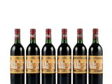four bottles of wine are lined up in a row