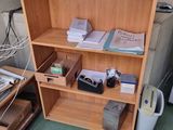 a bookshelf with a bunch of papers on top of it