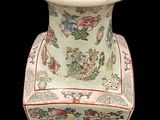 a white vase with a floral design on it