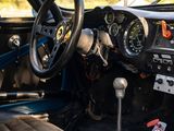 a dashboard and steering wheel of a car with a mountain in the background