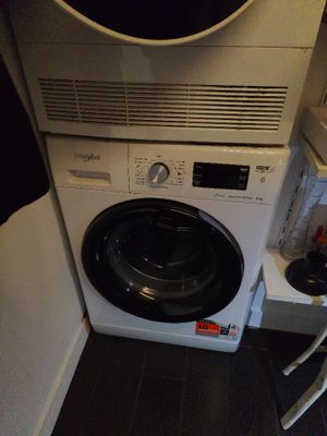 washing machine in the corner of a small room with a window