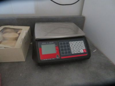 an image of a scale with a box of doughnuts on it