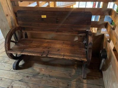 a wooden bench with a wheel on the back of it
