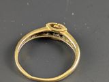 a close up of a gold ring with a diamond on it