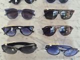 several pairs of sunglasses are on a table with a price tag