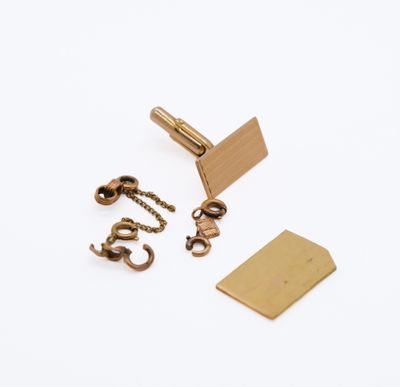 two pairs of brass cufflinks with chain and clasps on a white background
