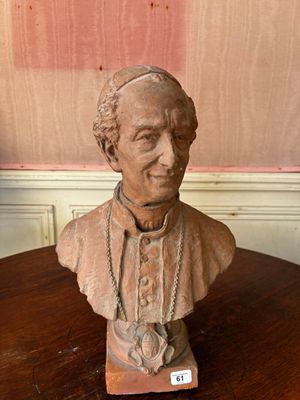 statue of a bust of a man on a table with a chain around his neck
