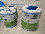 three rolls of blue and white yarn on a table
