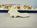 a white plate with a bird on it next to a tray of butterflies