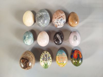 many different colored stones on a white surface