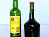 two bottles of alcohol sitting next to each other on a table