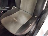 a dirty seat in the back of a car