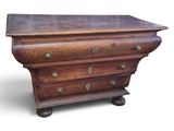 a small wooden chest of drawers on wheels on a white background