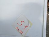 a white refrigerator with a red sticker on it