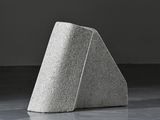 concrete sculpture of a triangular shape on a concrete floor