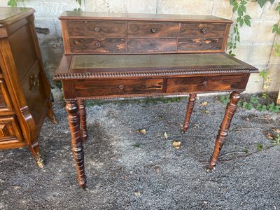 a small table with a drawer on it next to a dresser
