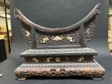 a very old wooden bench that is sitting on a table