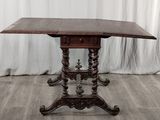 a wooden table with a carved top and a wooden base