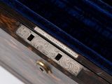 a close up of a wooden box with a key in it