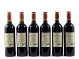 four bottles of wine are lined up on a white surface