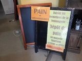 a sign that says pain and a sign that says debt