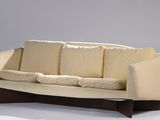 a white couch with pillows on it in a room