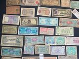 several different types of paper money are displayed on a table