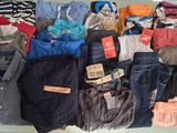 a lot of clothes that are sitting on a table
