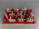 silver plated figurine of a group of soldiers on a red surface