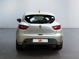 the rear end of a silver car in a room with a white wall
