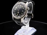 an image of a watch on a stand on a black surface