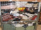 a metal cage filled with lots of items in a warehouse