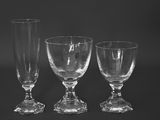 three empty wine glasses sitting next to each other on a table