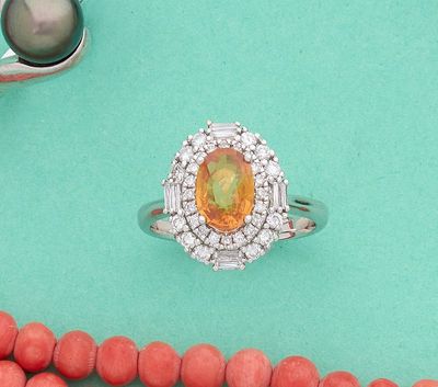une image représentant un collier, une bague et un collier de perles sur fond turquoise
