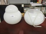 two white vases sitting on a table with a price tag on them
